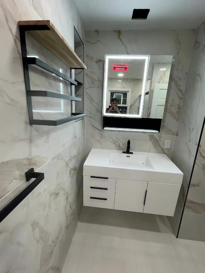 Modern bathroom with floating vanity and illuminated mirror
